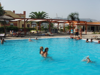 Bob and Elizabeth swimming across the pool